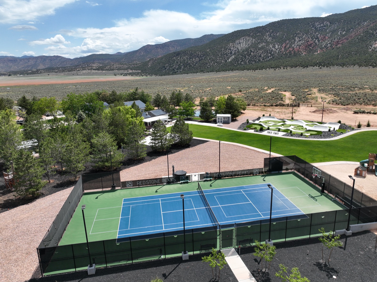 Redstone Peaks property with courts, pump track, and mountain views
